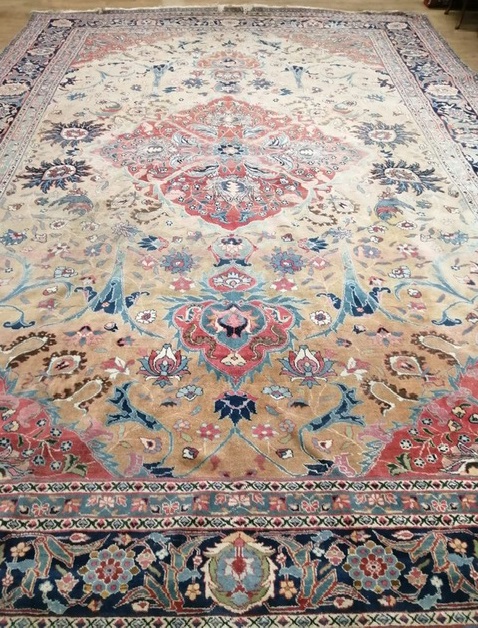 A Tabriz carpet, ivory ground with central lozenge 500 x 340cm